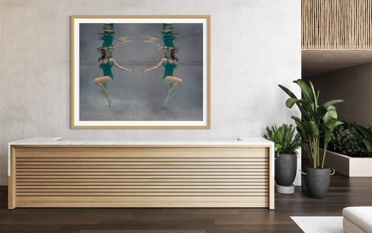 Shirley by Liesel.Art: A captivating fine art print featuring two beautiful girls floating in water, gazing at each other, their reflections shimmering in stunning green costumes."